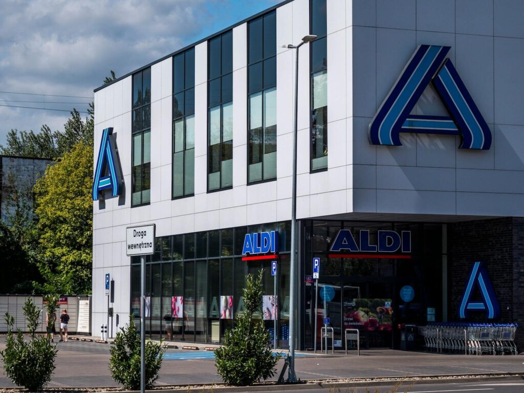 Modern Aldi supermarket with prominent signage in an urban setting.
